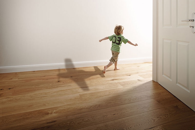 Young boy running through a house