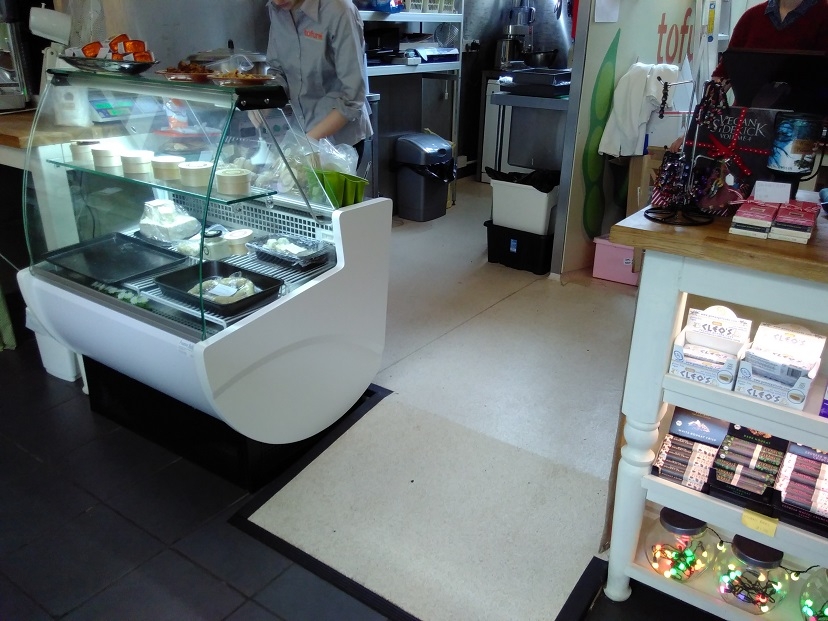 Tofurei staff preparing produce for customers at their counter