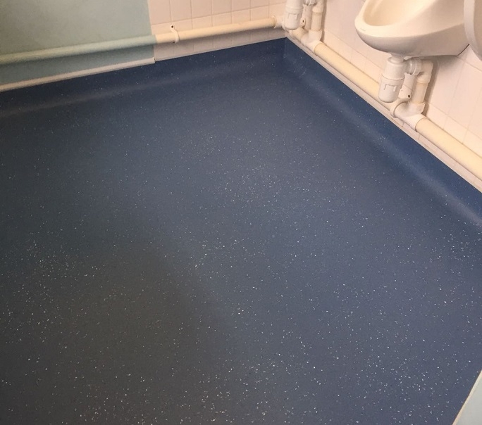 The safety flooring underneath the urinals in the men's toilets.
