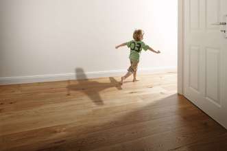 Young boy running through a house