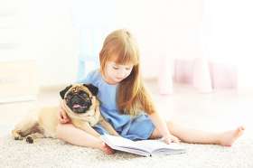 Girl with a pug on carpet